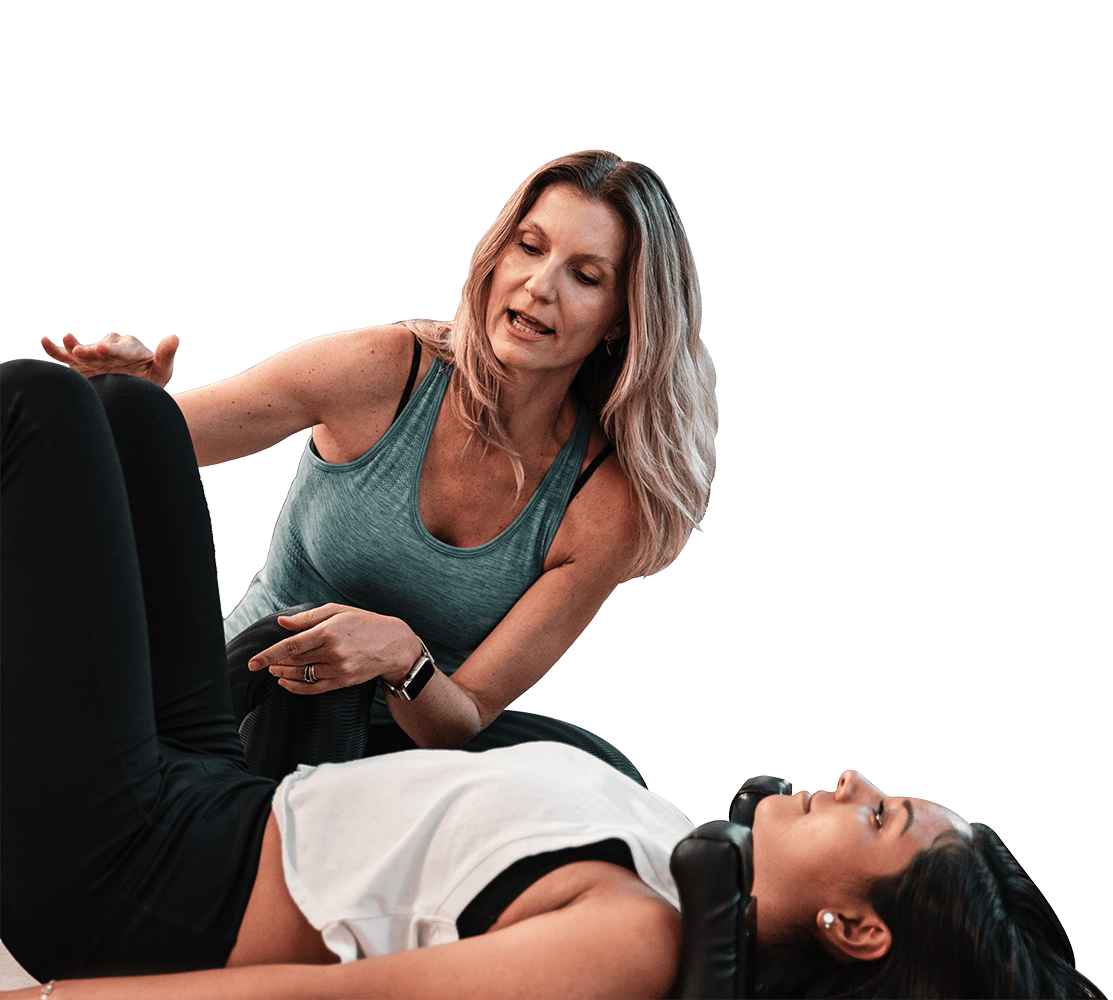 Woman teaching a Pilates student