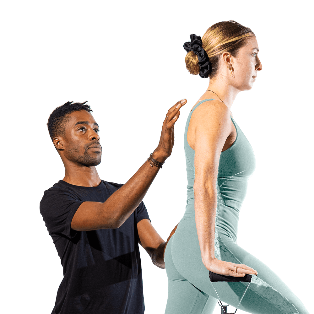 Pilates instructor aligning a client